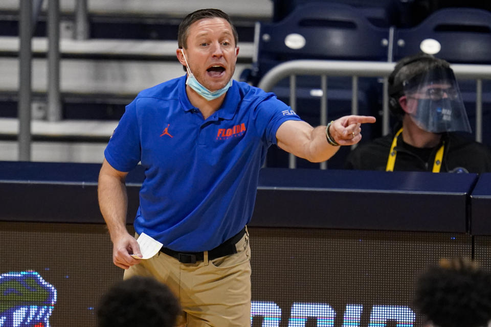 FILE - Florida head coach Mike White gestures in the first half of a first round game against Virginia Tech in the NCAA men's college basketball tournament at Hinkle Fieldhouse in Indianapolis, in this Friday, March 19, 2021, file photo. Florida might have its best defensive team in nearly a decade, an experienced group that seems to fit perfectly with coach Mike White’s style. (AP Photo/Michael Conroy, File)