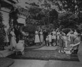 <p>The Queen and the Duke of Edinburgh at Government House in Auckland, New Zealand on Christmas Day. A man dressed as Santa gives presents to the Governor General's daughters.</p>