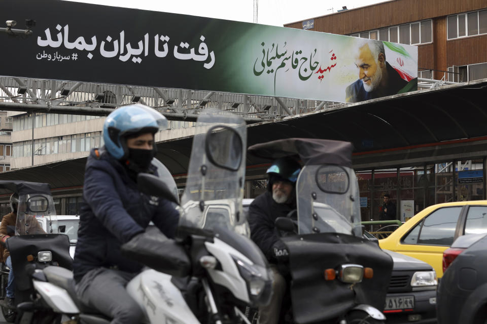 Vehicles drive past a billboard showing a portrait of Iranian Revolutionary Guard Gen. Qassem Soleimani, who was killed in a U.S. airstrike in Iraq, in Tehran, Iran, Saturday, Jan. 4, 2020. The Persian writings in the billboard read: "Martyr Hajj Qassem Soleimani, He went so that Iran can stay." (AP Photo/Vahid Salemi)