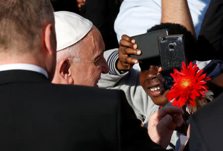 Pope Francis waves a he arrives to visit the Basilica of Saint Bartholomew on the Tiber island in Rome, April 22, 2017. REUTERS/Alessandro Bianchi