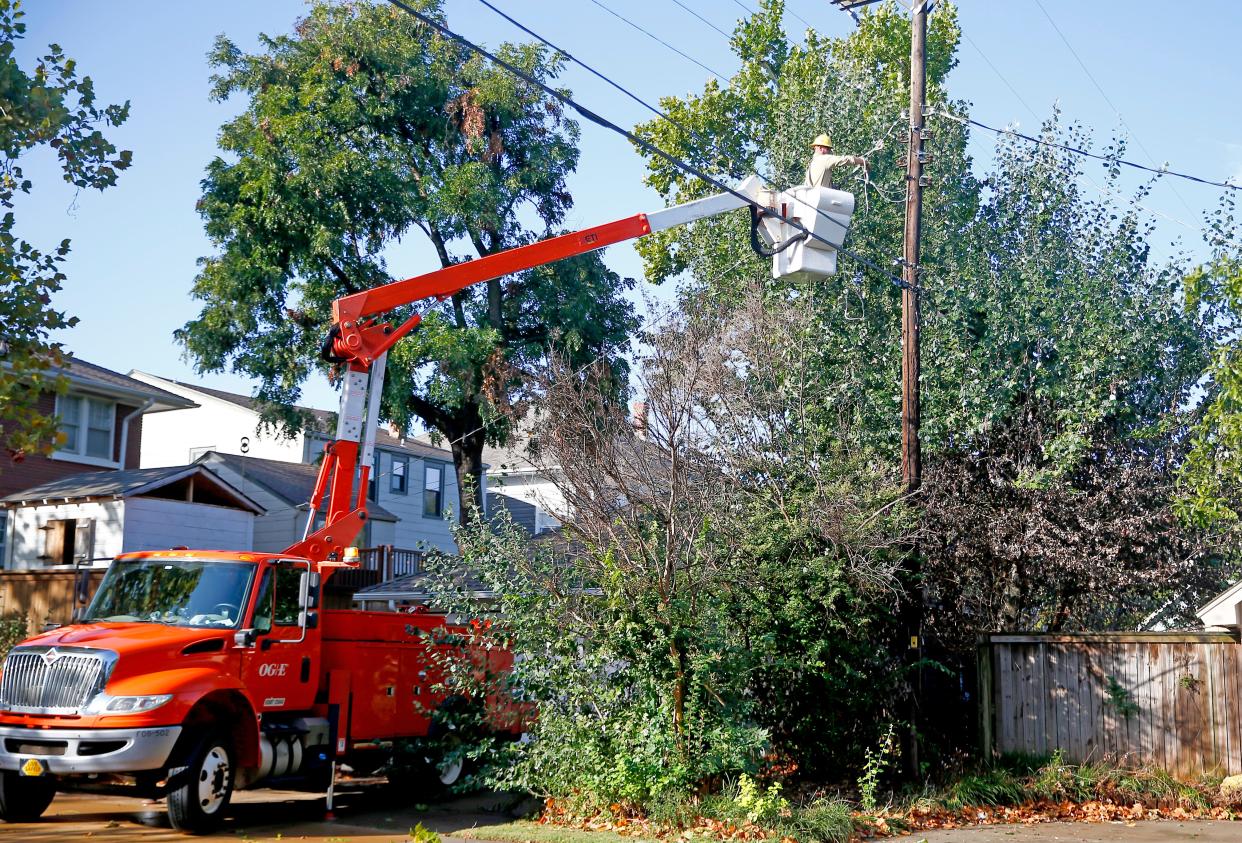 An OG&E crew repairs lines in the Heritage Hills neighborhood after severe storms.