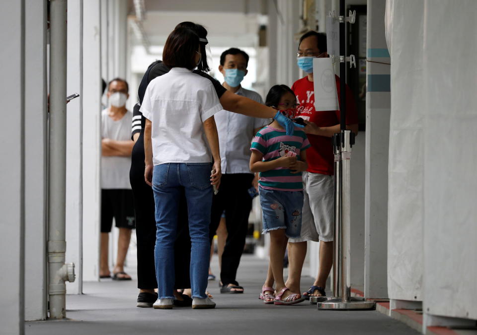 Residents queue up for their mandatory coronavirus disease swab tests in Singapore on 21 May, 2021. (PHOTO: Reuters)