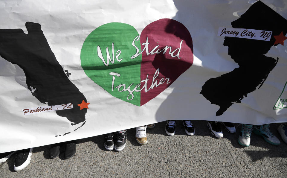 <p>Students from James Ferris High School hold a banner outside of the school during a student walkout in Jersey City, N.J. (Photo: Julio Cortez/AP) </p>