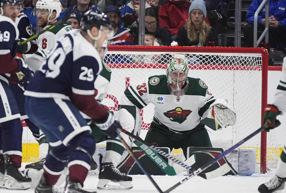 Minnesota Wild goaltender Filip Gustavsson (32) looks for a shot from Colorado Avalanche center Nathan MacKinnon (29) in the second period of an NHL hockey game Friday, March 8, 2024, in Denver. (AP Photo/David Zalubowski)