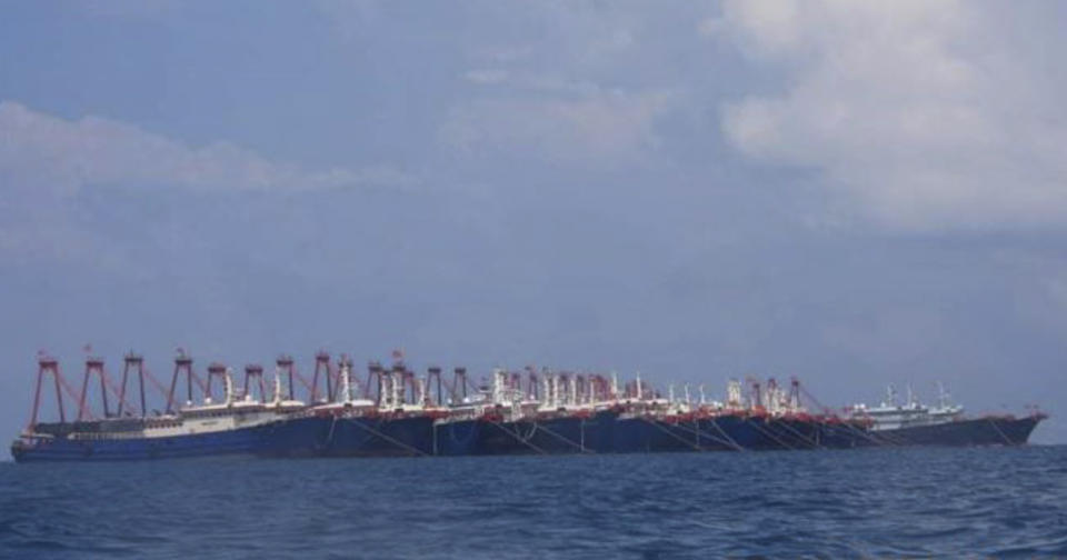 FILE - In this March 7, 2021, file photo provided by the Philippine Coast Guard/National Task Force-West Philippine Sea, some 220 Chinese vessels are seen moored at Whitsun Reef, South China Sea. The Philippine government has summoned the Chinese ambassador to press a demand for Chinese vessels to immediately leave the reef claimed by Manila in the disputed South China Sea and said the illegal presence was stoking regional tension, the Department of Foreign Affairs said Tuesday, April 13, 2021. (National Task Force-West Philippine Sea via AP, File)