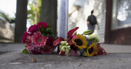 Flowers for the victims of Wednesday's shootings, are laid near a police barricade in Charleston, South Carolina, June 18, 2015. REUTERS/Randall Hill