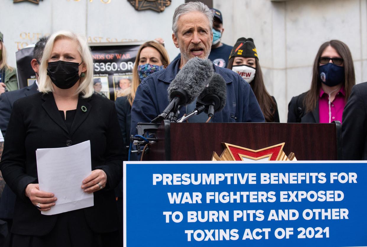Comedian Jon Stewart speaks alongside US Senator Kirsten Gillibrand, Democrat of New York, as they advocate for Congress to pass legislation to provide benefits for members of the US military exposed to burn pits while serving overseas, during a press conference on Capitol Hill in Washington, DC, April 13, 2021.