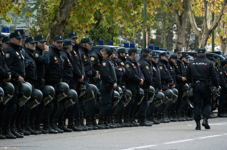 Spanish police stand before the Spanish league "Clasico" football match Real Madrid CF vs FC Barcelona at the Santiago Bernabeu stadium in Madrid on November 21, 2015