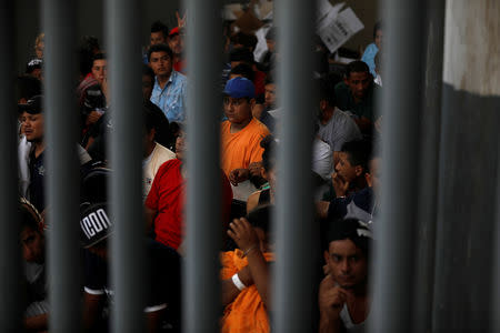 Migrants from Honduras, part of a new caravan from Central America trying to reach the United States, wait to be processed in an immigration facility in Ciudad Hidalgo, Mexico, January 17, 2019. REUTERS/Jose Cabezas