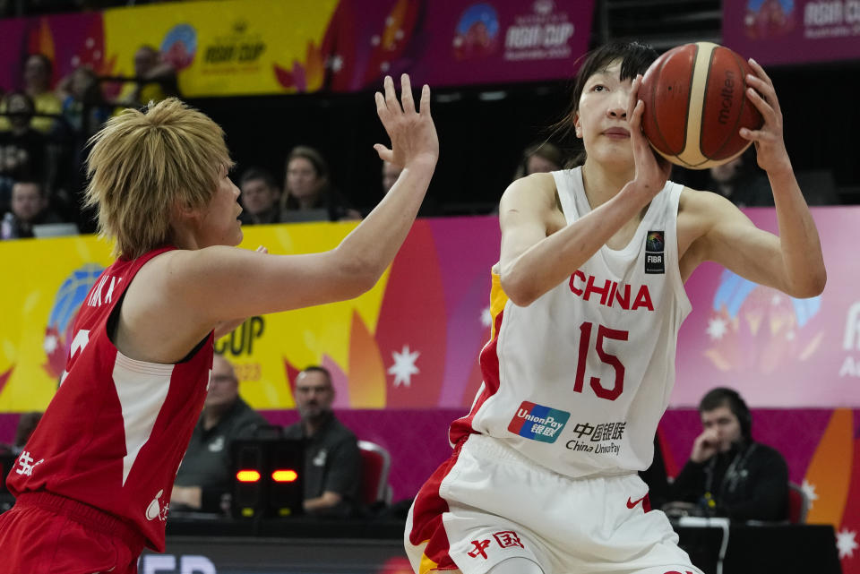 Japan's Maki Takada, left, attempts to block a shot at goal from China's Han Xu during the Asia Cup women's basketball final in Sydney, Australia, Sunday, July 2, 2023. (AP Photo/Mark Baker)