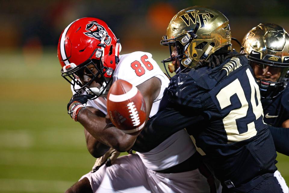 North Carolina State Wolfpack wide receiver Emeka Emezie (86) fumbles the ball on a hit by Wake Forest Demon Deacons defensive back Ja'Sir Taylor (24) in the fourth quarter at BB&T Field.