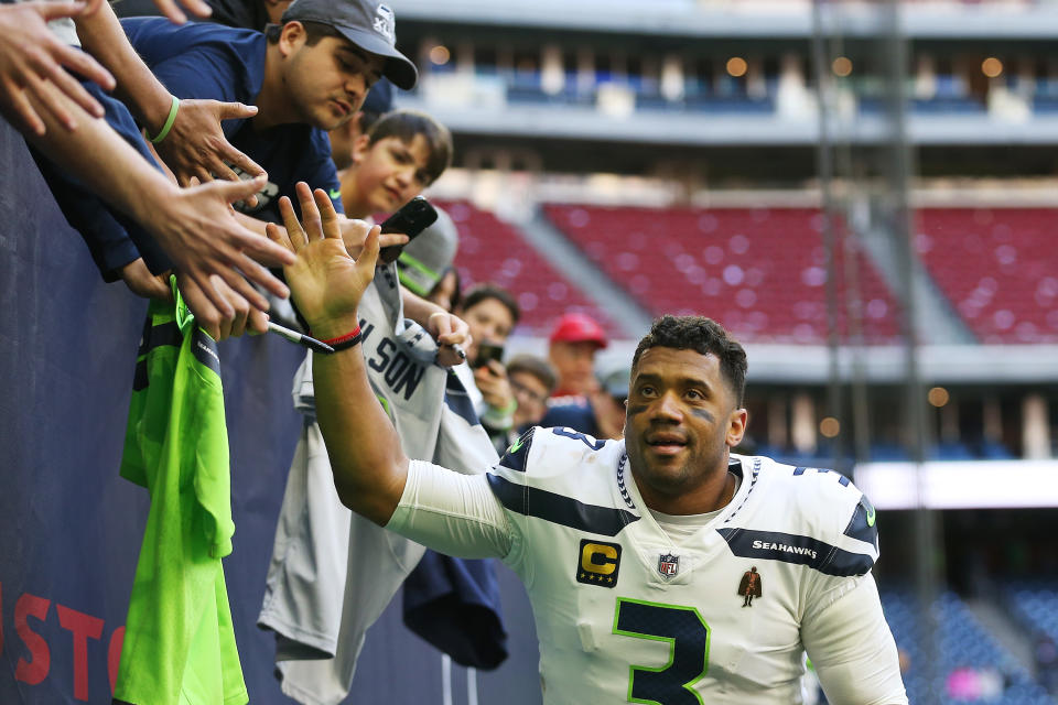 HOUSTON, TEXAS - DECEMBER 12: Russell Wilson #3 of the Seattle Seahawks celebrates with fans after defeating the Houston Texans 33-13 at NRG Stadium on December 12, 2021 in Houston, Texas. (Photo by Tim Warner/Getty Images)