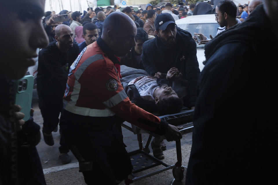 Palestinians wounded in the Israeli bombardment of the Gaza Strip are brought to the hospital in Deir al Balah, Gaza Strip, on Sunday, Dec. 24, 2023. (AP Photo/Adel Hana)