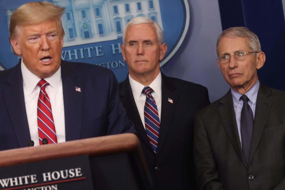 Dr Fauci and Mike Pence look on as Donald Trump leads a combative White House briefing, on 20 March 2020 (Reuters)