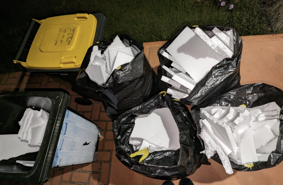 The Temple & Webster styrofoam packaging in black plastic bags and two bins. 