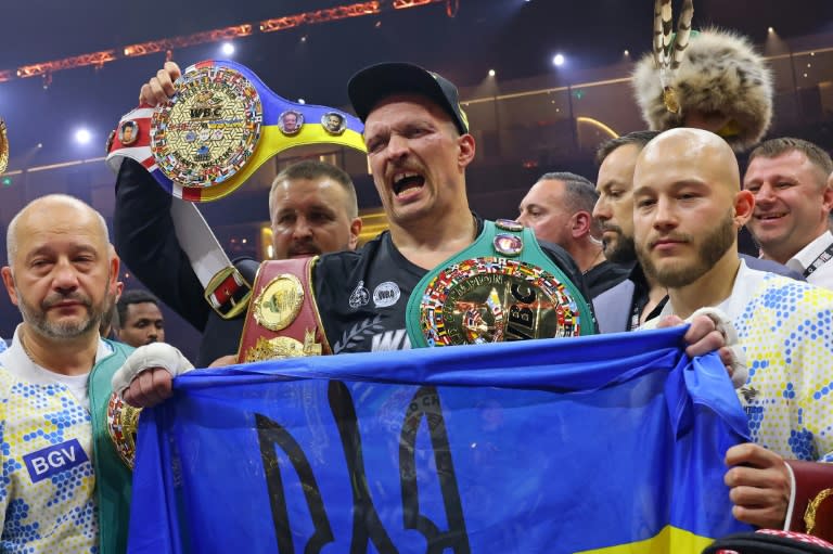 Ukraine's Oleksandr Usyk (C) celebrates his victory over Britain's Tyson Fury for the undisputed heavyweight world title (Fayez NURELDINE)