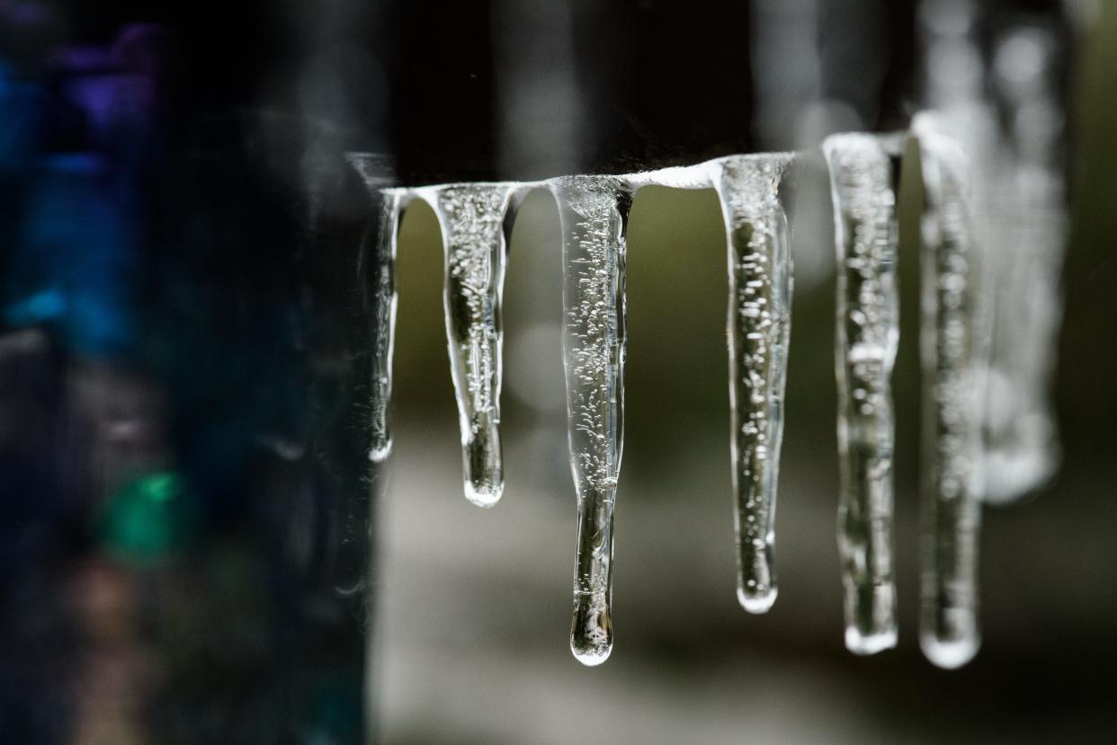 Icicles hang from a bird feeder in Fayetteville on Sunday, Jan. 16, 2022.