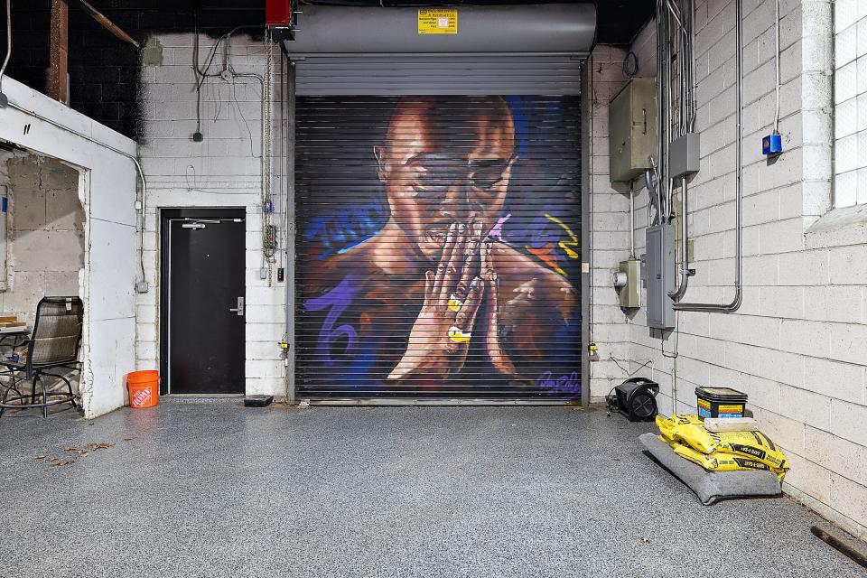 A large mural of Tupac painted on the inside of a steel garage door by award-winning artist Desiree Kelly at 2222 Puritan in Detroit.