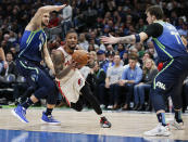 Portland Trail Blazers guard Damian Lillard, center, drives between Dallas Mavericks forwards Maxi Kleber, left, and Luka Doncic during the second half of an NBA basketball game, Friday, Jan. 17, 2020, in Dallas. The Mavericks won 120-112. (AP Photo/Brandon Wade)