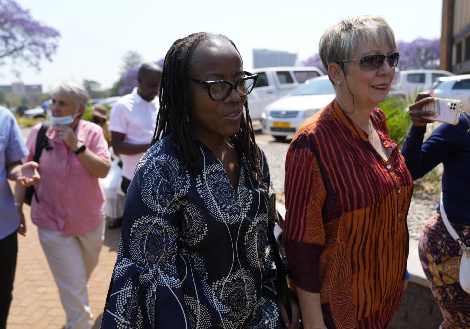 Zimbabwean writer Tsitsi Dangarembga, left, and her co accused Julie Barnes arrive at the magistrates courts for judgment in her court case in Harare, Thursday, Sept. 29, 2022. Dangarembga faces charges of inciting public violence for protesting against corruption and the rule of law in Zimbabwe.(AP Photo/Tsvangirayi Mukwazhi)