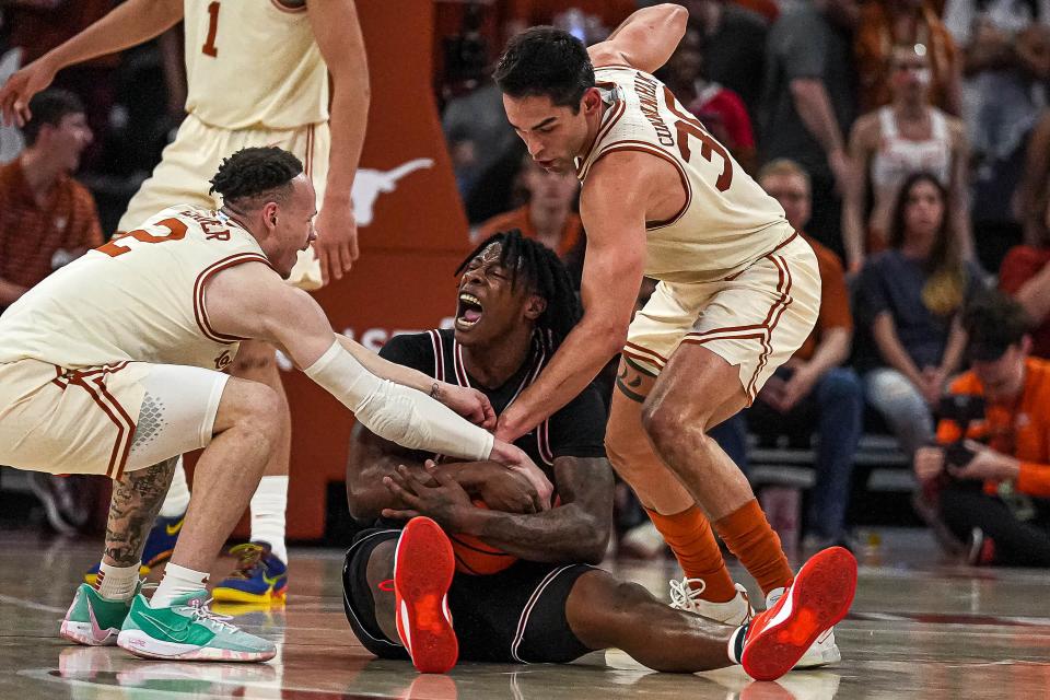 Texas guard Chendall Weaver, left, and forward Brock Cunningham smother Oklahoma State guard Quion Williams during the Longhorns' 81-65 win Saturday at Moody Center. Weaver and Cunningham combined for 24 points along with 11 rebounds, three triples, three assists and a pair of steals.