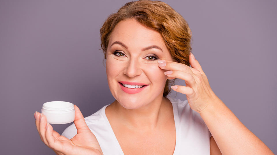 Woman applying eye cream