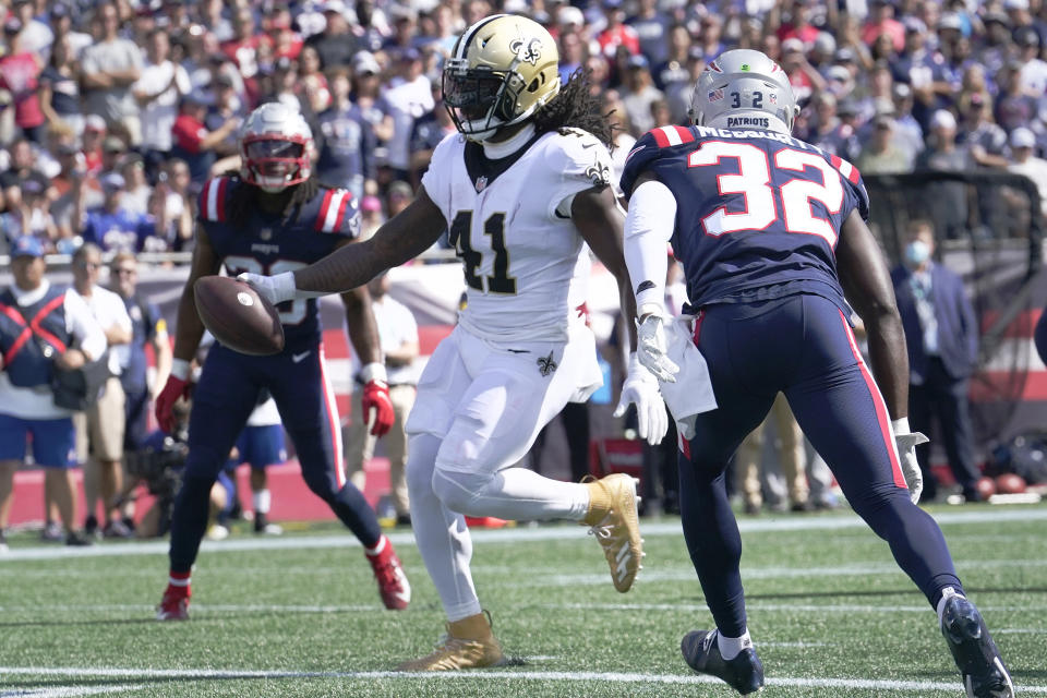 New Orleans Saints running back Alvin Kamara (41) steps into the end zone for a touchdown ahead of New England Patriots free safety Devin McCourty (32) during the first half of an NFL football game, Sunday, Sept. 26, 2021, in Foxborough, Mass. (AP Photo/Steven Senne)