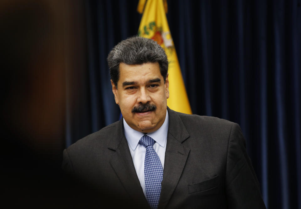 Venezuela's President Nicolas Maduro stands up after a press conference at the Miraflores Presidential Palace, in Caracas, Venezuela, Tuesday, Sept. 18, 2018. Venezuela and China have agreed to joint investments Maduro announced on Tuesday. (AP Photo/Ariana Cubillos)