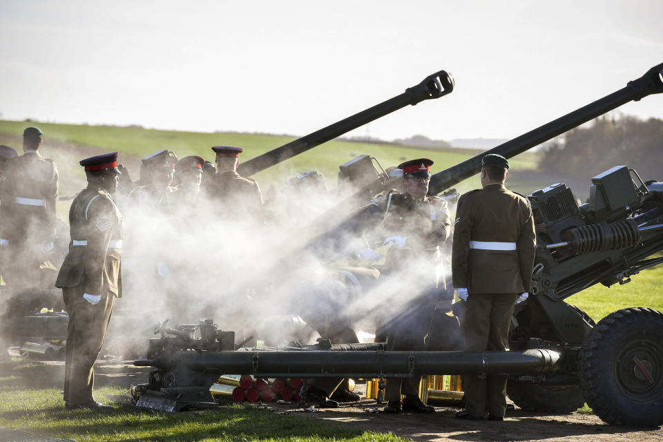 Soldiers from the Royal Artillery man their 105mm light guns at Stonehenge, seen in background, in Wiltshire, southern England, as they fire 100 rounds before falling silent as the clock strikes 11am to mark the centennial for the end of the First World War. Ceremonies across the world are marking the 100th anniversary of the signing of the Armistice which marked the end of the First World War. (Ben Birchall/PA via AP)