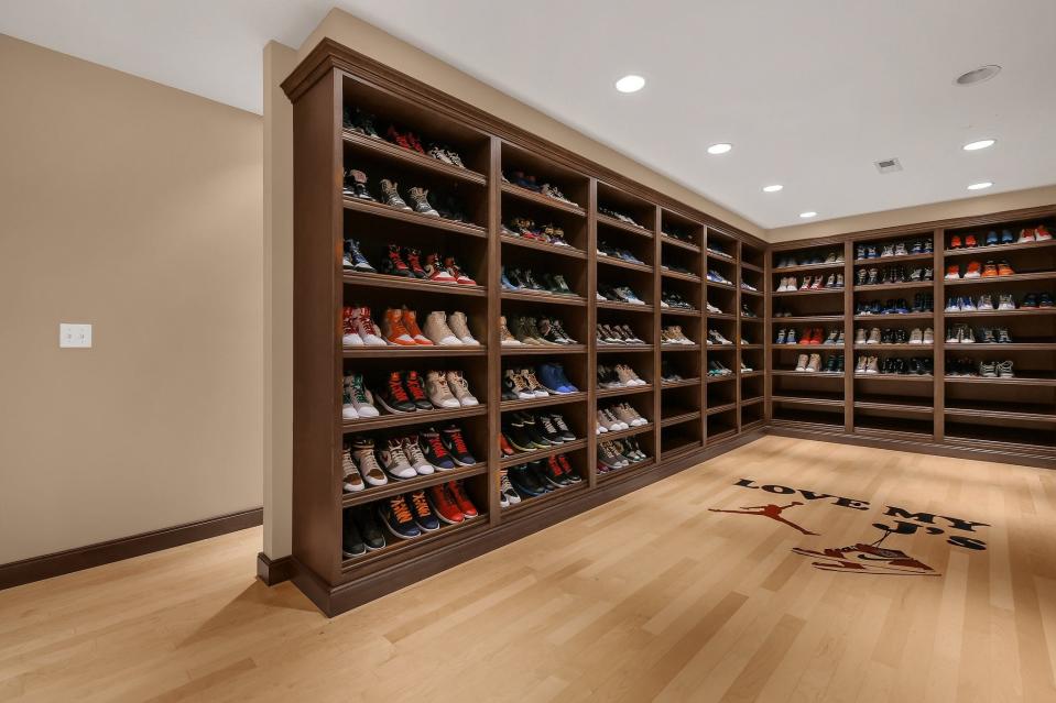 A bedroom converted into a closet displays Kevin Martin's shoe collection.