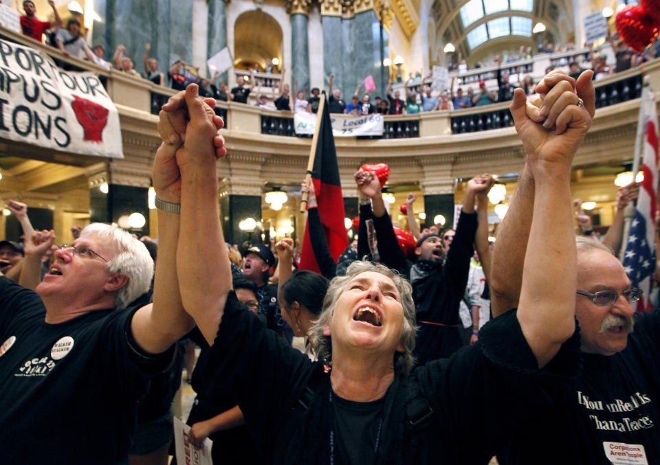 FILE - Mary Kay Baum joins hundreds of labor union members at a rally to protest the collective bargaining measures of Wisconsin Governor Scott Walker's administration at the Wisconsin State Capitol Building in Madison, Wis., Aug. 25, 2011. A Wisconsin judge is scheduled to hear arguments Tuesday, May 28, 2024, in a case brought by unions representing teachers and public workers who are trying to end the state’s near-total ban on collective bargaining for most public employees. (AP Photo/Wisconsin State Journal, John Hart, File)/Wisconsin State Journal via AP)