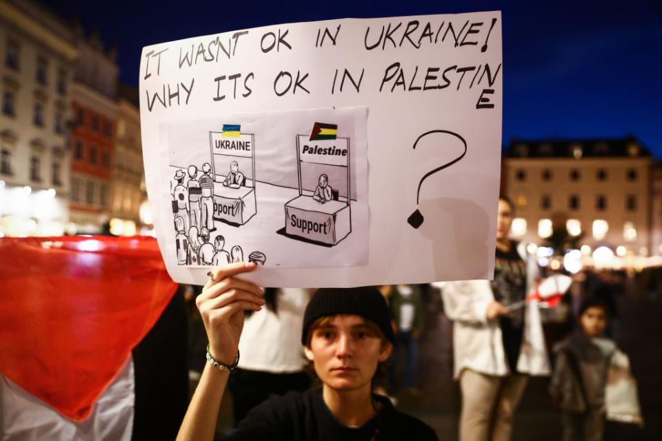 A protestor holds a banner during solidarity with Palestine demonstration at the Main Square in Krakow, Poland on Oct. 13, 2023. Protests in support of both Israel or Palestine have been held worldwide after the Hamas Oct. 7 attack against Israel. (Beata Zawrzel/NurPhoto via Getty Images)