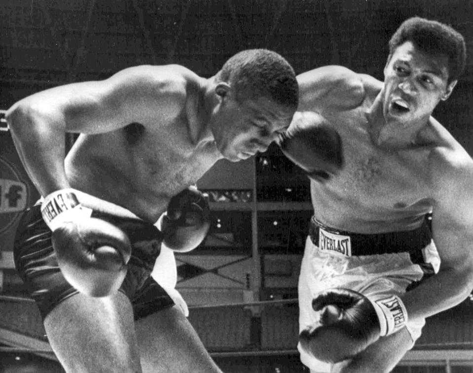 FILE - In this Aug. 5, 1967, file photo, Jimmy Ellis, right, lands a right hook to the head Leotis Martin during their 12-round World Heavyweight title elimination fight in Houston, Texas. Ellis, a former heavyweight boxing champion who trained with fellow Louisville fighter Muhammad Ali and squared off against some of his era's best fighters, has died in his hometown Tuesday, May 6, 2014. He was 74. Ellis' brother, Jerry, said the ex-champion died at a Louisville hospital Tuesday after suffering from Alzheimer's disease in recent years.(AP Photo)/File)