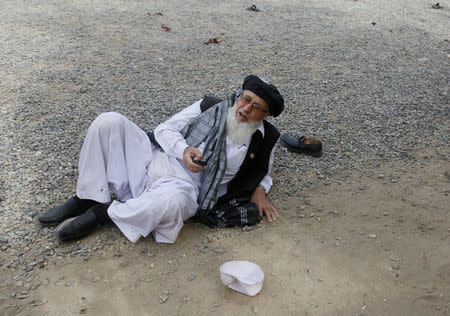 An injured Afghan man lies on the ground after a suicide attack blast in Kabul, Afghanistan June 3, 2017. REUTERS/Stringer