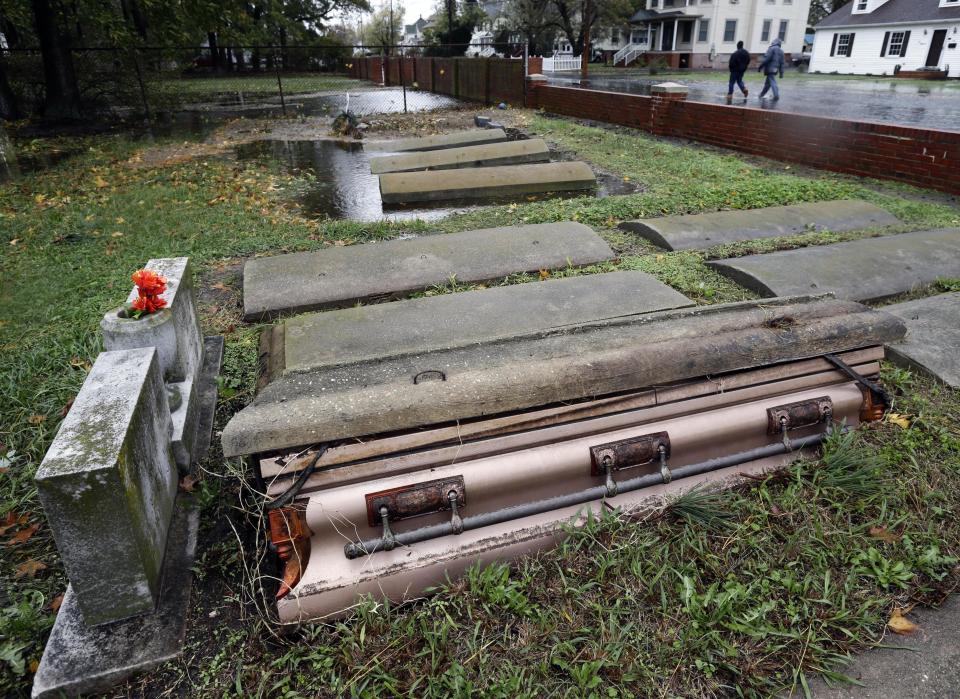A casket floated out of the grave in a cemetery in Crisfield, Md. after the effects of superstorm Sandy Tuesday, Oct. 30, 2012. Hundreds of people were displaced by floodwaters in Ocean City and in Crisfield. At the same time, 2 feet of snow fell in westernmost Garrett County, were nearly three-quarters of residents lost power. (AP Photo/Alex Brandon)