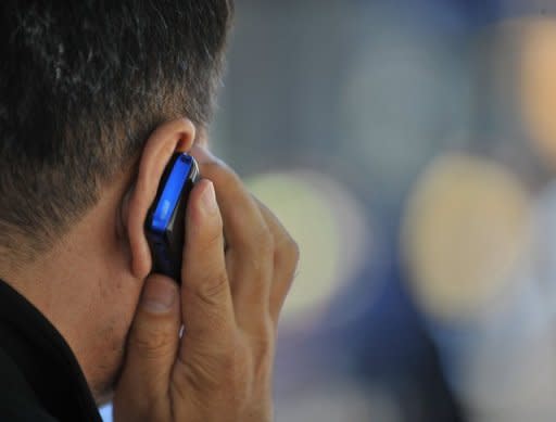 A man uses a cell phone in New York. The use of cell phones and other wireless communication devices are "possibly carcinogenic to humans", the World Health Organisation's cancer research agency said Tuesday