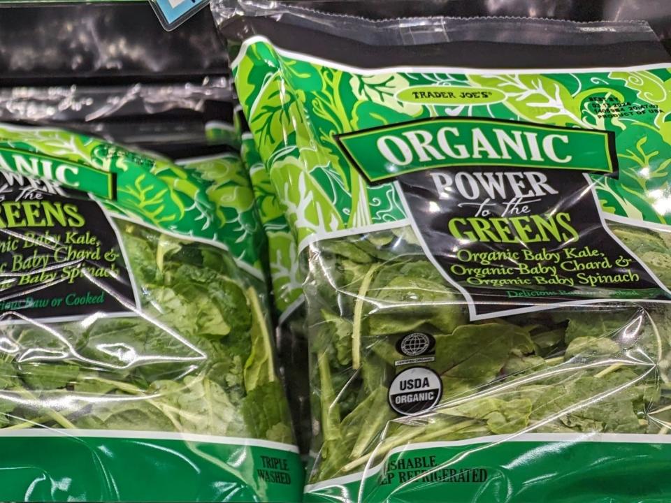 Bags of Trader Joe's "Power to the Greens" organic lettuce.