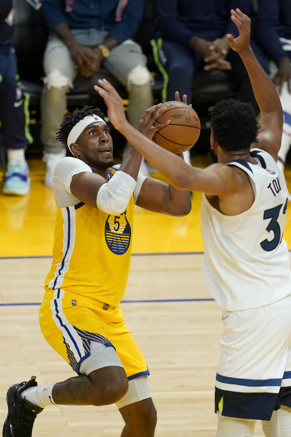 Golden State Warriors center Kevon Looney, left, shoots against Minnesota Timberwolves center Karl-Anthony Towns during the second half of an NBA basketball game in San Francisco, Thursday, Jan. 27, 2022. (AP Photo/Jeff Chiu)