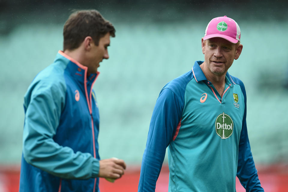 Pictured right, Australia coach Andrew McDonald chats with captain Pat Cummins in India.