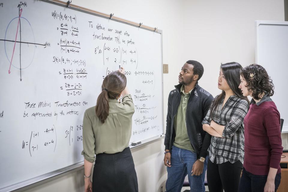 A number of barriers keep young women out of the physics field, but having role models to look up to can lead them toward success. <a href="https://media.gettyimages.com/id/643999287/photo/professor-talking-to-students-in-college-classroom.jpg?s=612x612&w=0&k=20&c=hD3t9QFlVw5otISs1svH3wCCFJ9cXDR84xoqIJcja-4=" rel="nofollow noopener" target="_blank" data-ylk="slk:Hill Street Studios/DigitalVision via Getty Images;elm:context_link;itc:0;sec:content-canvas" class="link ">Hill Street Studios/DigitalVision via Getty Images</a>