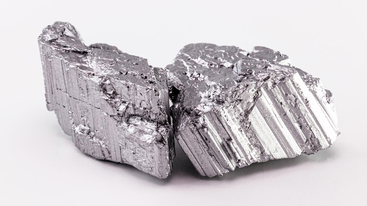  A silver-colored raw chunk of neodymium stone, part of the rare earth group, the world's strongest magnetic ore used in the technology industry. 