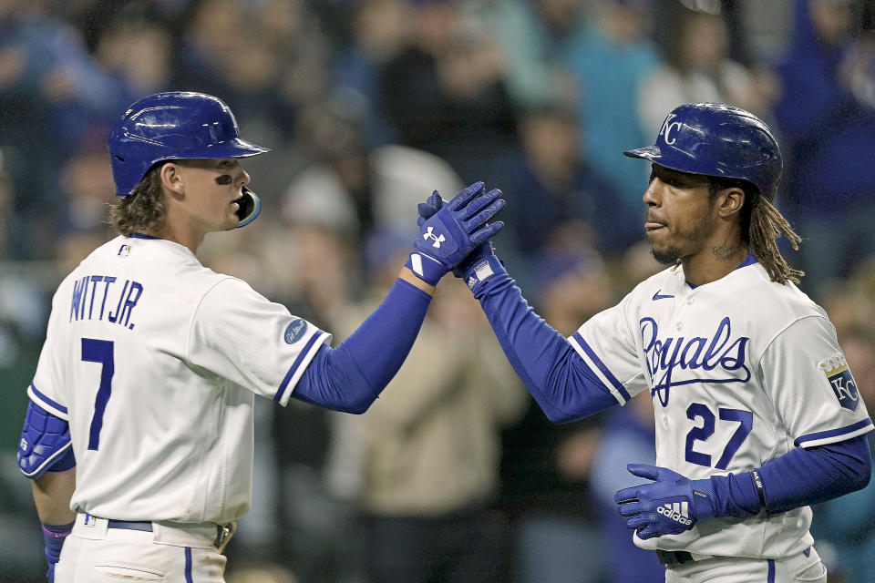 Kansas City Royals' Adalberto Mondesi (27) celebrates with Bobby Witt Jr. (7) after scoring on a single by Whit Merrifield during the fourth inning of a baseball game against the Detroit Tigers Thursday, April 14, 2022, in Kansas City, Mo. (AP Photo/Charlie Riedel)