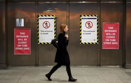A woman walks past the closed entrance to the Underground station at Waterloo during a strike by members of two unions in protest at ticket office closures and reduced staffing levels, in London, Britain January 9, 2017. REUTERS/Dylan Martinez