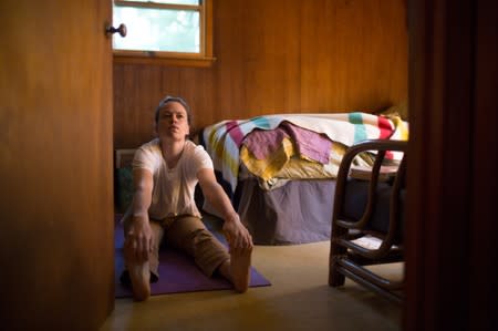 Quail Hill farmer Alicia Mountain stretches before the day's farm work in Amagansett