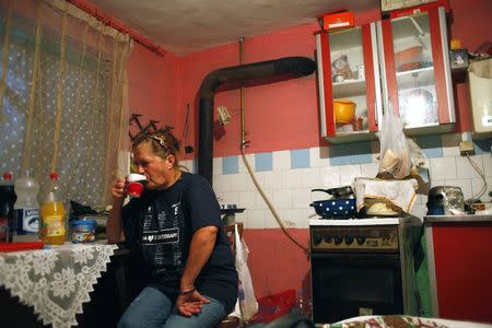 Milica Milkovic, a packaging worker with Serbian farming company Agroziv, drinks coffee in her home in the village of Srpski Itebej, near Vrsac July 7, 2014. REUTERS/Djordje Kojadinovic