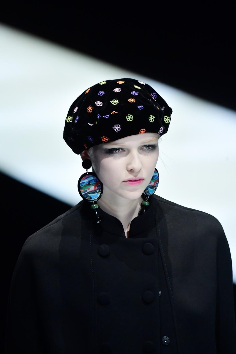 Model wears an embroidered black velvet beret at the Giorgio Armani Fall/Winter 2017 show.