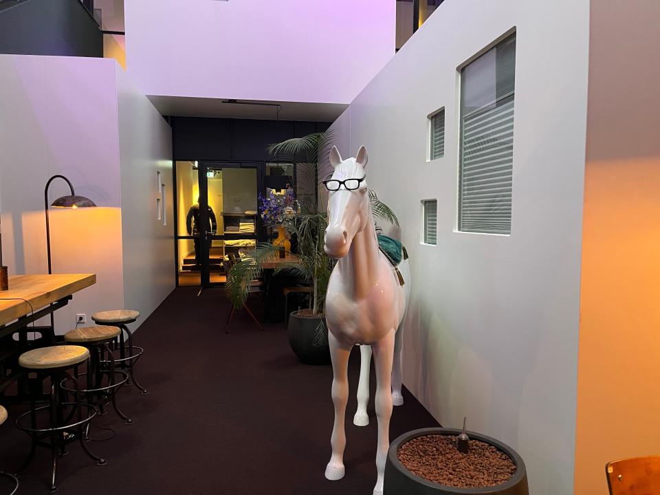 Common area with a statue of a horse and purple-tinted lighting