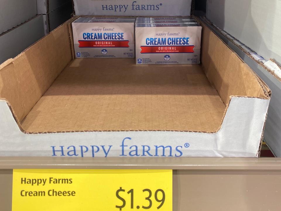 nearly empty display of happy farms cream cheese at aldi