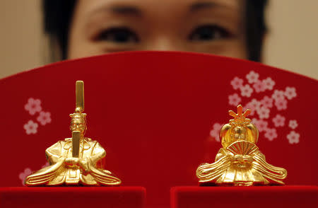 Japanese ornamental "hina" dolls, made of pure gold, is unveiled at the Ginza Tanaka store in Tokyo February 23, 2011. REUTERS/Yuriko Nakao/Files