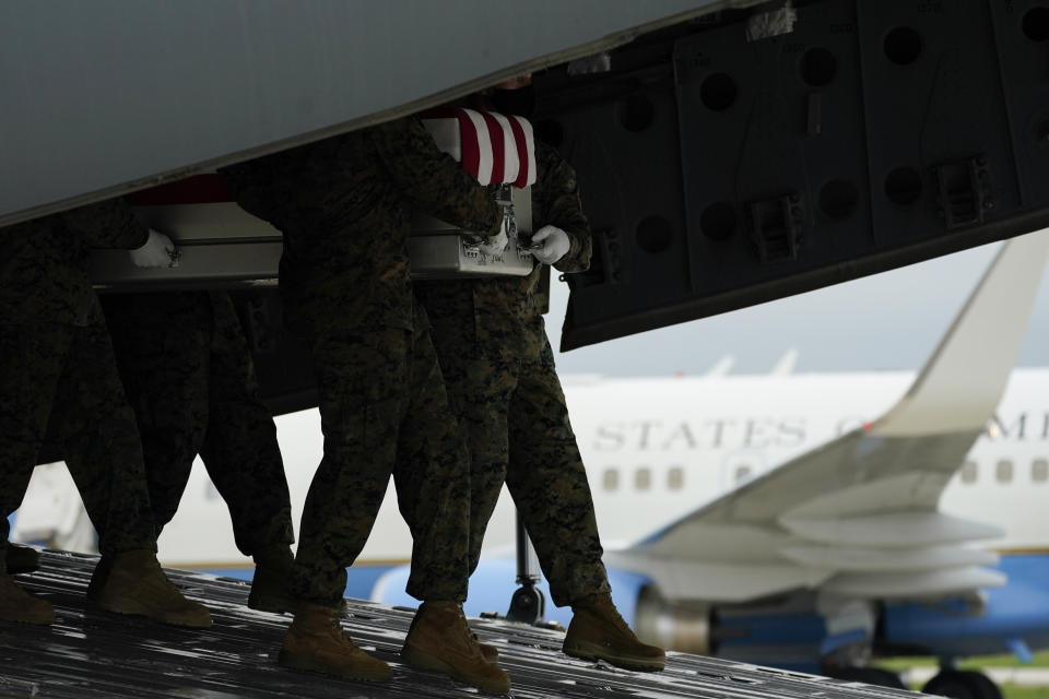 A carry team moves a transfer case containing the remains of Marine Corps Staff Sgt. Darin T. Hoover, 31, of Salt Lake City, on Aug. 29, 2021, at Dover Air Force Base, Del. According to the Department of Defense, Hoover died in an attack at Afghanistan's Kabul airport, along with 12 other U.S. service members. (AP Photo/Carolyn Kaster)